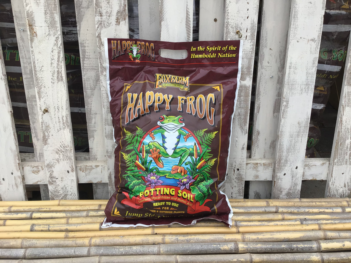 Small Bag of Happy Frog potting soil on a wooden surface at Paisley Gardens in Northfield, MN.