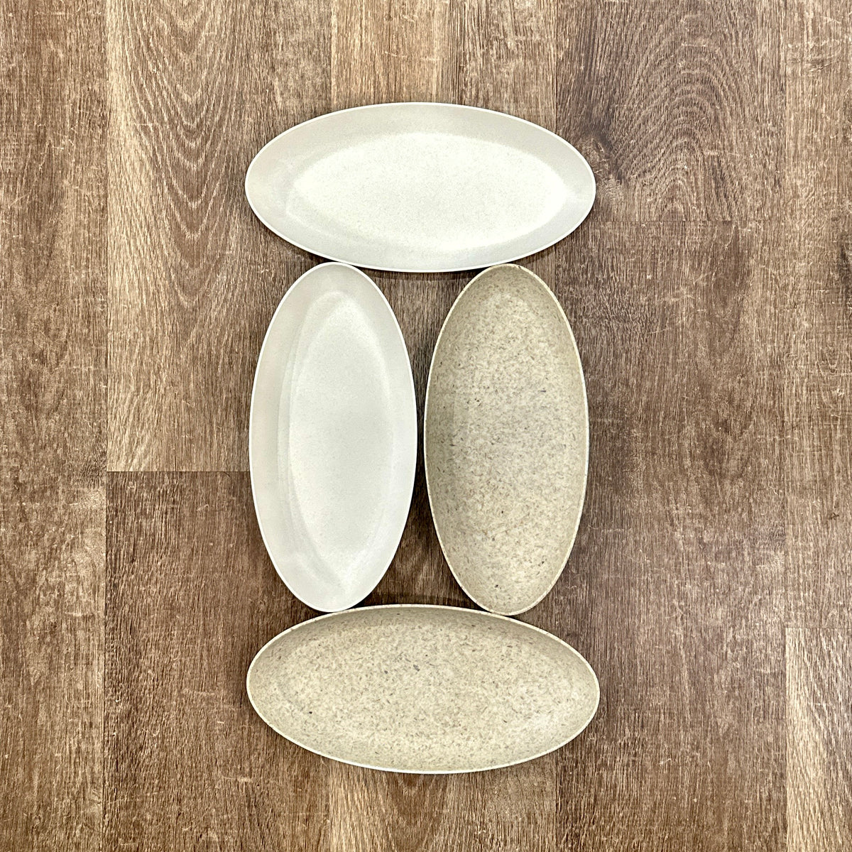 Four oval trays in two different colors arranged on a brown wood surface at Paisley Gardens in Northfield, MN. 